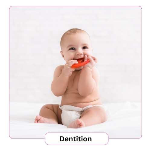 A baby is mouthing a toy in her mouth